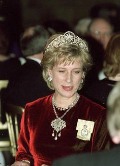 a woman in a red dress wearing a tiara