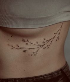 a woman's stomach with small flowers on it