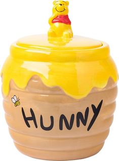 a winnie the pooh cookie jar with a honey pot on top that says humpy