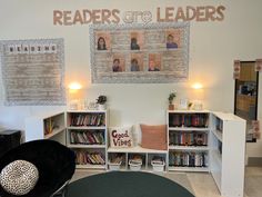 a room with several bookshelves and pictures on the wall above them that read readers are leaders