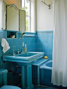 a bathroom with blue tile walls and floor