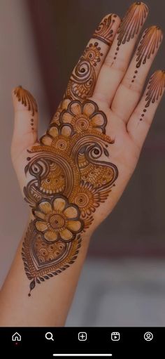 the hand is decorated with henna designs