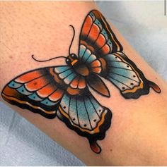 a colorful butterfly tattoo on the left arm and leg, with an orange stripe around it's wings