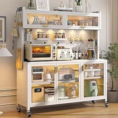 a white cabinet with glass doors and shelves filled with dishes on wheels in a living room