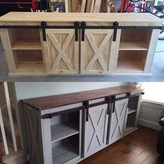 an entertainment center with sliding doors and shelves