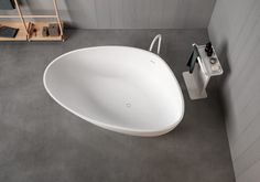 an oval shaped white sink in a bathroom