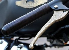 the handlebars on a motorcycle are decorated with gold and black designs, as well as eagle emblems