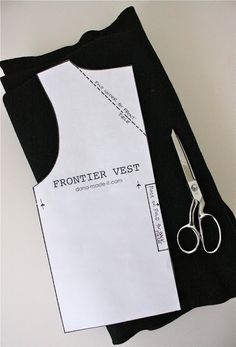 a pair of scissors sitting on top of a piece of paper