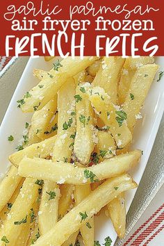 french fries with parmesan cheese on top are served on a white platter