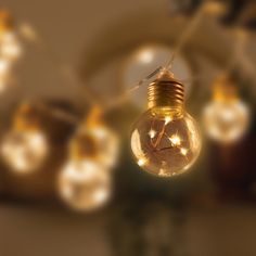 a light bulb with some small lights in the back ground and on top of it