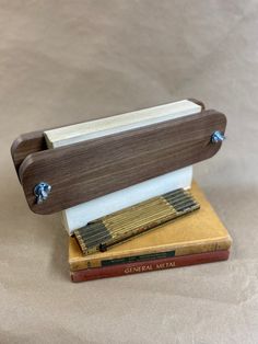 a small wooden instrument sitting on top of a book