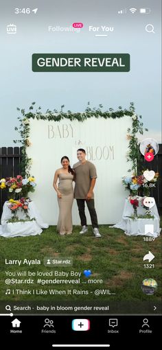 a man and woman standing next to each other in front of a sign that says gender reveal