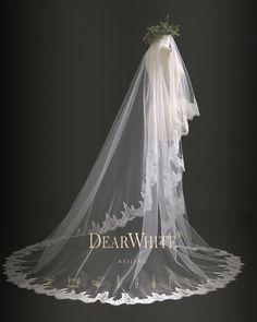 a veil with flowers on it is displayed in front of a black background and the words dear white