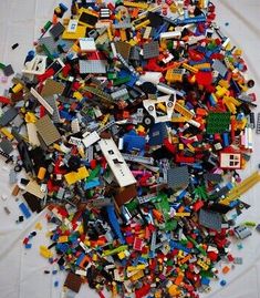 a pile of legos sitting on top of a white table next to each other