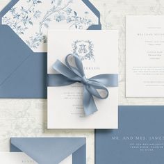 a blue and white wedding suite with a bow on the front, matching card and envelope