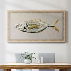 a fish painting hanging on the wall above a dining room table