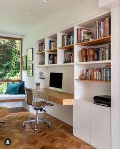 a home office with bookshelves, desk and chair