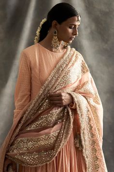 Editor's Note Dotted Jacquard Cotton Gathered Angrakha With Lycra Net Chudidaar. Paired With A Silk Organza Dupatta Hand Embroidered With Fine Gota Patti. Edged With Fine Kiran. Fabric: Jacquard Cotton, Organza Color: Peach Care: Dry Clean Only About the Designer Itrh makes a high-end luxury Indian ethnic wear made using exquisite and endangered age-old crafts such as kalamkari, madhubani, chikankari, zardozi, and gota weaving. The focus of the house is to cherish the beauty of handcrafted luxur Organza Angrakha, Blouse Yoke, Fancy Suit, Pakistani Fashion Party Wear, Cotton Dupatta, Pakistani Bridal Wear, Organza Dupatta, Embroidered Neckline, Pakistani Bridal