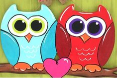 two colorful owls sitting on top of a tree branch with a heart in front of them