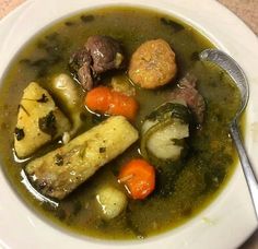 a white bowl filled with soup and vegetables