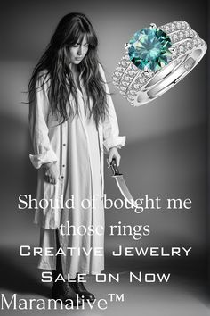 a woman holding a knife in her hand and wearing a ring with diamonds on it