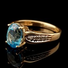 This is a beautiful blue Topaz ring. The oval stone is set into a yellow gold band inset with tiny diamonds. The ring is a size US 7 1/2 The stone measures about 5/16 inch (9mm) tall 1/4 inch (7mm) wide It weighs 3.3 grams. It's marked 'FL 10k' on the inside of the band. It's in good wearable condition. The ring shows some wear from being an estate piece of jewelry. Please inspect photos closely before purchasing. This item will be shipped fully insured in the United States. Just send me a messa Heirloom Oval Topaz Ring With Diamond Accents, Blue Oval Jewelry Stamped 14k, Oval Yellow Gold Topaz Ring With Diamond Accents, Blue Oval Birthstone Ring With Diamond Accents, Gold Oval Blue Topaz Birthstone Ring, Oval Topaz Ring With Diamond Accents In 14k Gold, Tiny Diamond, November Birthstone, Oval Stone