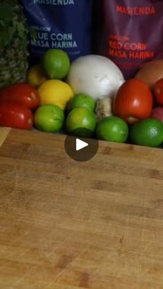 a wooden cutting board topped with lots of fruits and vegetables