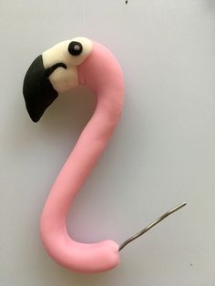 a pink flamingo with a black and white face on it