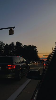 cars stopped at a traffic light in the evening