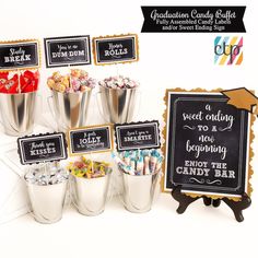 an assortment of candy in buckets next to a chalkboard sign