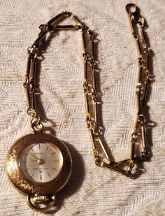 "Beautiful 1950's Bucherer 17 Jewels, GoldPlated watch pendant. Weave craved design. Goldtone link necklace, measures 9\" long Manual  wind movement, Swiss made. Is running and keeping time. In excellent vintage condition Measures 1\" in diameter" Jewel Pendant Necklace, Ocean Springs Ms, Chip Bead Necklace, Agate Stone Necklace, Watch Pendant, Wind Movement, Acrylic Bracelet, Ocean Springs, Pendant Watches