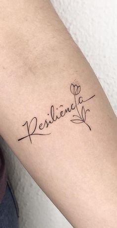 a woman's arm with a tattoo that says, resiline on it