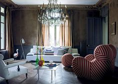 a living room filled with furniture and a chandelier