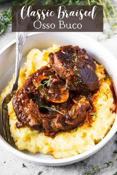 a white bowl filled with mashed potatoes and meat