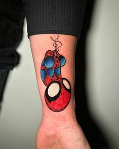 a spider - man tattoo on the left inner forearm and wrist is shown in this image