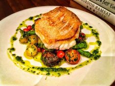 a white plate topped with food on top of a wooden table