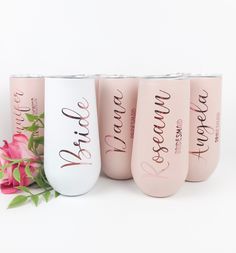 three personalized wine tumblers next to pink roses