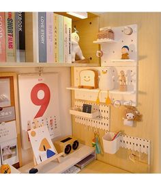 there is a desk with many items on the shelves and in front of bookshelves