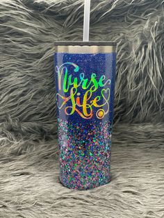 a blue glitter tumbler with the words nurse life on it and a straw sticking out of