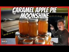 there is a man standing in front of jars filled with liquid and the words caramel apple pie moonsshine