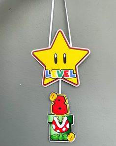 there is a star hanging on the wall next to a game character ornament