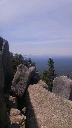 a person standing on top of a large rock