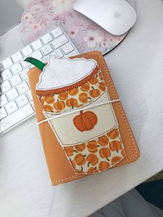 an orange and white cell phone case sitting on top of a desk next to a keyboard