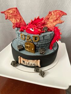 a birthday cake with a red dragon on top