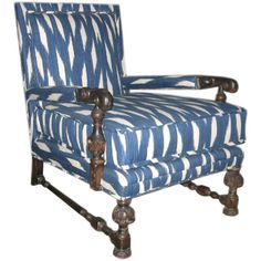 a blue and white striped chair with wooden legs