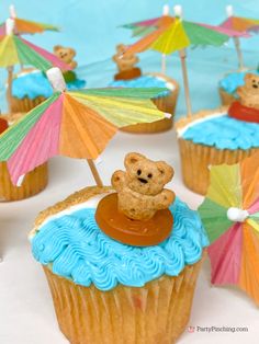 cupcakes decorated with teddy bears and umbrellas