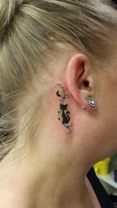 a woman with a small tattoo behind her ear