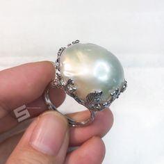 Very unique Baroque pearls adjustable band ring, pearls sized 16x23mm with strong luster which is a statement! With well-made sterling silver band, protect and goes well with the shape of pearls, makes the shape of pearl more special, every pearl has been picked by myself, to make sure the shape is intersting and the luster is good enough. Quality: AAA Color: Natural White Luster: highest sheen and luster Nacre: lustrous and thick nacre Blemish: 97% - 99% Clear Shape: Baroque Size:16x23mm approx Fine Jewelry Silver Pearl Ring With High Luster, Silver Pearl Ring With High Luster, Silver Oval Pearl Ring With High Luster, Silver High Luster Pearl Ring Fine Jewelry, Silver Pearl Ring With High Luster For Gift, Silver High Luster Pearl Ring For Gift, Luxury High Luster Pearl Ring In Silver, Luxury High Luster Silver Pearl Ring, Big Pearl