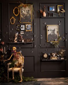 there are many pictures on the wall and one is in front of a chair with a skeleton sitting next to it