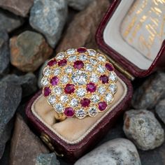 This beautiful cocktail ring is accented with twenty-nine (29), bead set, round brilliant cut diamonds and thirteen (13), bead set, round mixed cut natural rubies. The ring measures 22.8mm at the top, rises 9.2mm above the finger, tapering to 2.5mm wide and 1.2mm thick at the base of the shank. This ring is currently a size 5.25. Ruby Cluster Diamond Ring, Ruby Multi-stone Diamond Ring, Multi-stone Ruby Cluster Diamond Ring, Ruby And Diamond Multi-stone Round Ring, Cluster Ruby Ring With Rose Cut Diamonds, Round Ruby Cluster Ring With Rose Cut Diamonds, Ruby Cluster Ring With Rose Cut Diamonds, Amethyst Jewelry, Natural Ruby